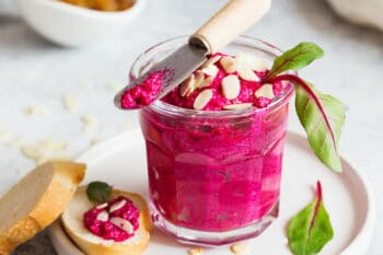 Beetroot dipping sauce in the glass decorated with almond petals and mangold leaves. Vegan recipes, plant-based dishes. Green living concept / snackconnection