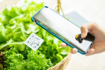 Customers buy organic vegetables from hydroponics farm and pay using QR code scanning system payment at food market shop. Technology and futuristic business. E wallet and digital cashless concept / snackconnection